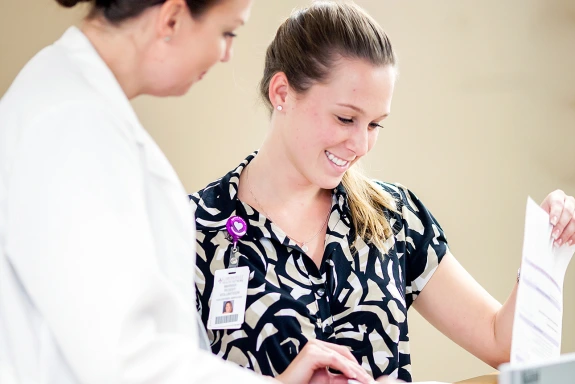 Health intern talking with doctor