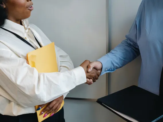 Two individuals shaking hands