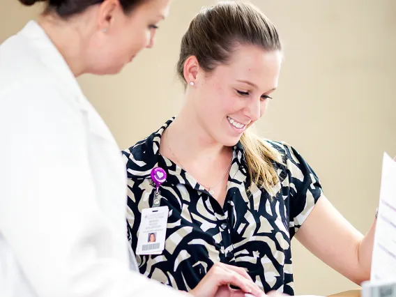 Health intern talking with doctor